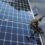 Close-up of solar panel cleaning using a brush tool in Tampa, Florida.